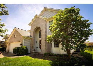 Charming two-story home with brick accents, arched entryway, and manicured landscaping at 11727 Wedgeport Ln, Fishers, IN 46037