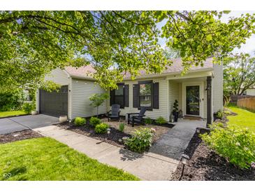 Charming home featuring a well-manicured lawn, cozy seating area, and inviting entrance at 14291 Holly Berry Cir, Fishers, IN 46038