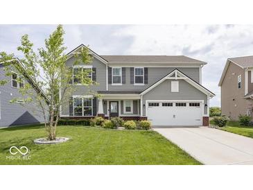 Charming two-story home with gray siding, attached two car garage, and a well manicured front yard at 2780 Cormorant Dr, Greenwood, IN 46143