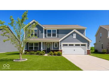 Charming two-story home featuring a manicured lawn, attached two-car garage, and beautiful curb appeal at 2780 Cormorant Dr, Greenwood, IN 46143