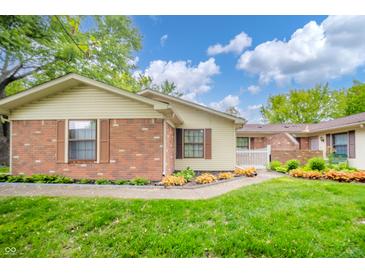 Charming single story home with well maintained lawn, garden and brick facade at 4316 London Ct, Anderson, IN 46013