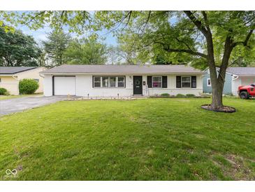 Charming single-story home featuring a well-manicured lawn and welcoming front entrance with black door at 4482 Priscilla Ave, Indianapolis, IN 46226