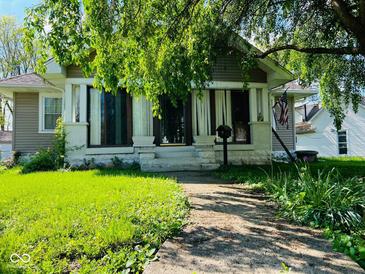 Charming home featuring a cozy front porch and a well-maintained lawn at 4850 E University Ave, Indianapolis, IN 46201