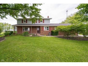 Charming two-story home with a well-manicured lawn and mature trees at 5388 W Hazelrigg Rd, Thorntown, IN 46071