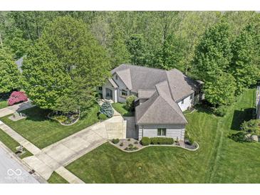 Stunning aerial view of a brick home featuring lush landscaping and a spacious driveway at 7421 Meadow Violet Ct, Avon, IN 46123