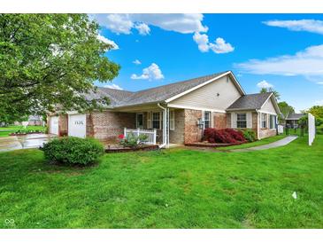 Charming single-story home with a well-manicured lawn, brick accents, and inviting curb appeal at 7840 Park Ward Pl, Indianapolis, IN 46259