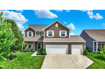 Beautiful two-story home featuring a brick facade, lush green lawn, and an attached two-car garage at 1286 Brookdale Ct, Franklin, IN 46131