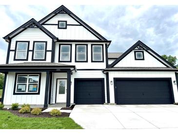 Two-story home with a modern farmhouse design, black trim, and an attached two-car garage at 1534 Trichel Dr, Greenwood, IN 46143