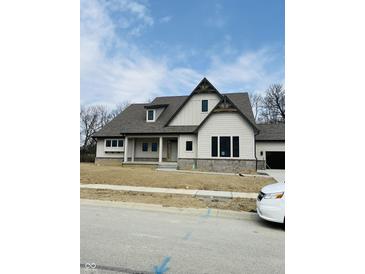 Charming two-story home boasts a modern design and a welcoming front entrance at 15434 Spring Winds Dr, Carmel, IN 46033