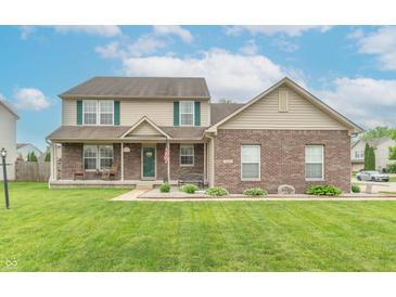 Charming two-story home boasts a well-manicured lawn, a cozy front porch, and classic curb appeal at 1603 Quinn Creek Dr, Brownsburg, IN 46112