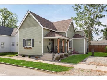 Charming two-story home with a well-manicured lawn and inviting front porch at 1609 S G St, Elwood, IN 46036