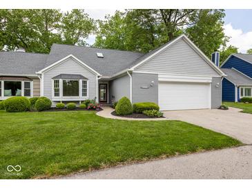 Charming home with a well-manicured lawn, attached garage, and lovely landscaping at 3430 Bay Road South Dr, Indianapolis, IN 46240
