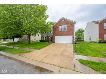 Two-story home with brick and siding, features a two car garage and manicured lawn at 5522 Grassy Bank Dr, Indianapolis, IN 46237
