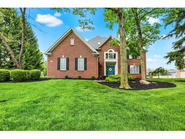 Beautiful brick home with lush green lawn and well-maintained landscaping at 7248 River Birch Ln, Indianapolis, IN 46236