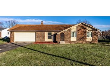 Charming brick home featuring an attached garage and well-maintained front lawn at 8510 E Mcgregor Rd, Indianapolis, IN 46259