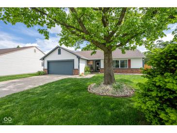 Charming single-story home featuring a lush front yard and attached garage at 1084 Lake W Dr, Brownsburg, IN 46112