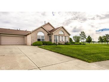 Charming brick home with well-manicured lawn, attached garage, and large windows at 11646 Winding Wood Dr, Indianapolis, IN 46235