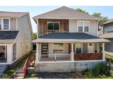 Charming two-story home featuring a cozy front porch with stylish design elements at 1212 S Senate Ave, Indianapolis, IN 46225