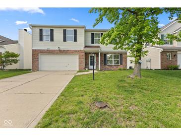 Traditional two-story home with a large front yard, attached garage, and charming curb appeal on a sunny day at 12422 River Valley Dr, Fishers, IN 46037