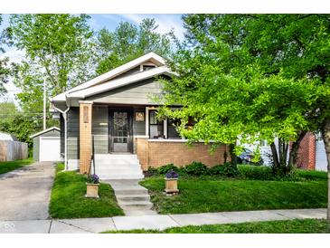 Charming home exterior with a well-manicured lawn and welcoming front porch at 1426 N Euclid Ave, Indianapolis, IN 46201