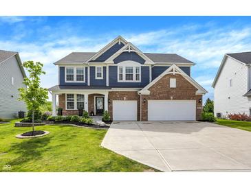 Inviting two-story home featuring a brick and siding facade, attached two-car garage, and well-manicured lawn at 15717 Hush Hickory, Westfield, IN 46074