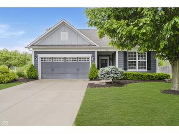 Charming home featuring a gray two-car garage, blue siding, and a lush green lawn at 18630 Goldwater Rd, Westfield, IN 46062