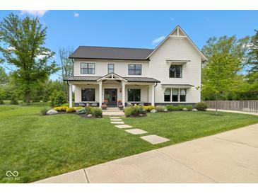 Charming two-story home with black accents, manicured lawn, and inviting front porch seating at 20400 Chatham Hills Blvd, Westfield, IN 46074