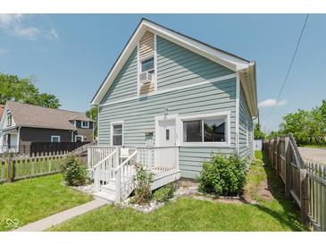 Charming two-story home with light blue siding, white trim, and a cozy front porch at 2230 Pleasant St, Indianapolis, IN 46203