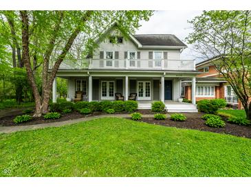 Charming two-story home featuring a welcoming front porch and a well-maintained front yard at 4130 N Meridian St, Indianapolis, IN 46208