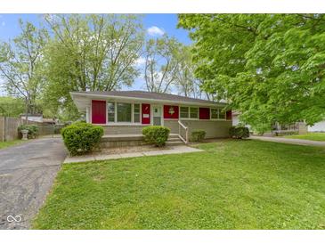 Charming single-story home with a well-maintained lawn and a red trim, offering great curb appeal at 7835 E 50Th St, Indianapolis, IN 46226