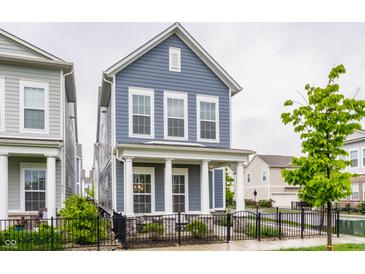 Charming two-story home featuring a welcoming front porch with classic white columns and a well-manicured front yard at 965 Astor Ln, Carmel, IN 46032