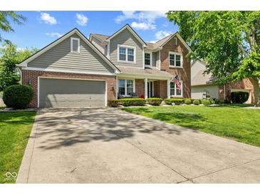 Charming two-story home featuring a well-manicured lawn and attached two car garage at 10988 Eaton Ct, Fishers, IN 46038