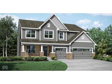 Charming two-story home with gray siding, brick accents, and a two-car garage at 1239 Thornwood Dr, Greenwood, IN 46143