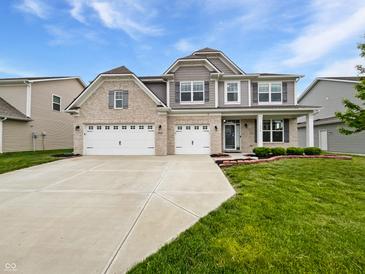 Charming two-story home with brick and siding and an attached three-car garage at 1276 Sanderling Dr, Greenwood, IN 46143