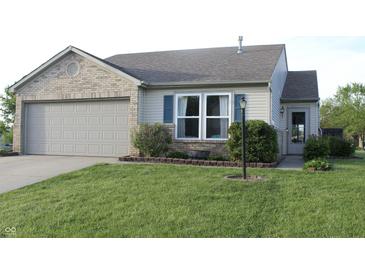 Charming single-story home with a brick and siding exterior, attached garage, and well-manicured lawn at 1461 Ripplewood Dr, Danville, IN 46122