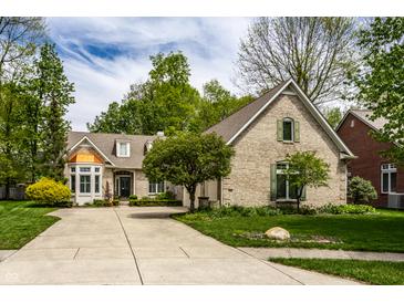Charming brick home with manicured lawn, mature trees, and a spacious driveway at 3556 Towne Dr, Carmel, IN 46032