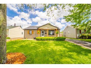 Charming home with inviting front porch, manicured lawn, and lush greenery at 433 N 15Th Ave, Beech Grove, IN 46107