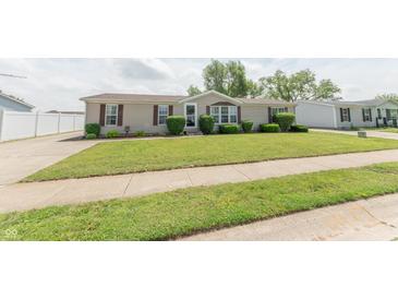 Charming single-story home featuring manicured lawn and mature landscaping at 4641 Autumn Ridge Dr, Columbus, IN 47203