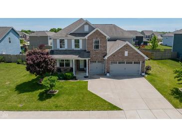 Beautiful two-story home featuring a brick facade, three-car garage, and well-maintained landscaping at 4863 Sherlock Dr, Westfield, IN 46062