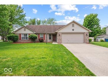 Charming ranch-style home with a well-manicured lawn, two-car garage, and inviting front entrance at 6034 Doverton Dr, Noblesville, IN 46062