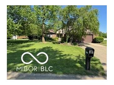 Charming home featuring a spacious front yard, mature trees, and a classic mailbox at 8835 Winding Ridge Rd, Indianapolis, IN 46217