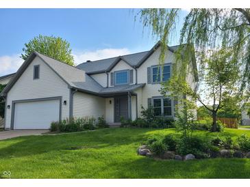 Charming two-story home with a well-manicured lawn, attached garage and tasteful landscaping, perfect for suburban living at 13497 Dunes Dr, Carmel, IN 46032
