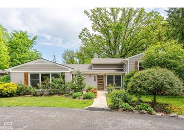 Charming single-story home with beautifully landscaped front yard and inviting walkway at 140 Meridian Hills Blvd, Indianapolis, IN 46260