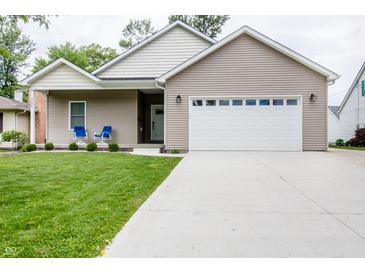 Charming single-story home featuring a well-manicured lawn and a two-car garage at 2686 Lafayette Ave, Columbus, IN 47201