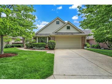 Charming single Gathering home with a manicured front yard and a two-car garage at 3033 Daum Ct, Carmel, IN 46033