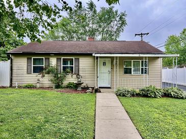 Charming single-story home featuring well-manicured landscaping and a welcoming covered porch at 3645 Winings Ave, Indianapolis, IN 46221