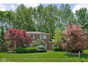 Charming two-story home with mature landscaping and a well-manicured lawn at 38 Hawthorne Ct, Carmel, IN 46033