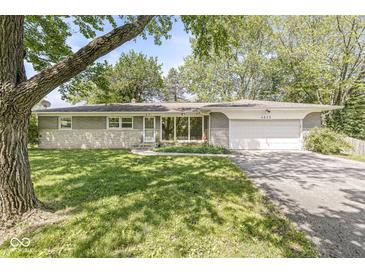 Charming single-story home featuring a well-maintained lawn and attached garage at 4622 S Franklin Rd, Indianapolis, IN 46239