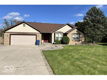 Charming home featuring a two-car garage, well-maintained lawn, and classic architectural details at 6143 Roberts Pl, Indianapolis, IN 46220