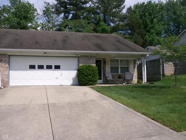 Single-story home featuring a lush lawn, front seating, and attached garage and long driveway at 6723 S New Jersey St, Indianapolis, IN 46227